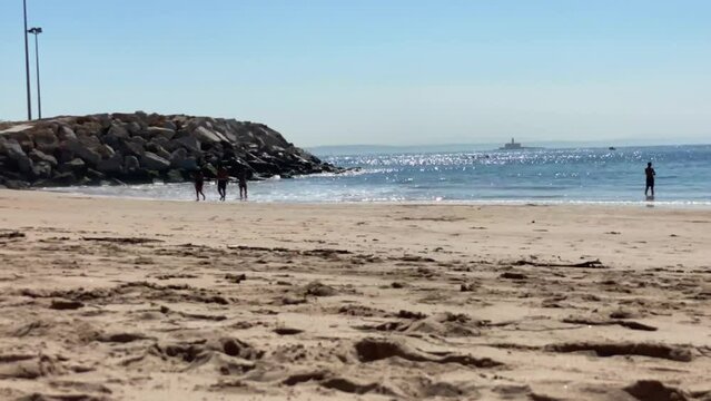 Timelapse of amazing beach in sunny day with bugio in background viewed from torre beach in Carcavelos