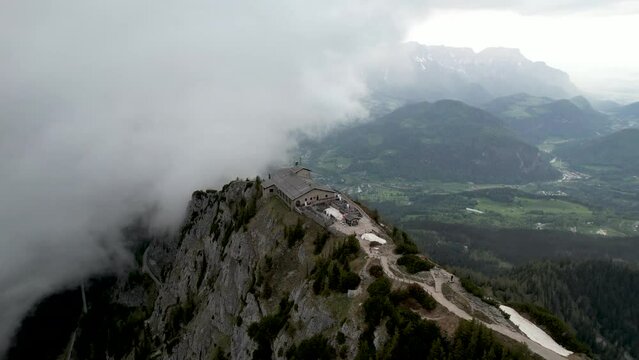 Circling Aerial View of Berchtesgaden Eagle's Nest retreat with clouds and valley below