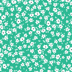 Cute floral pattern. Seamless vector texture. An elegant template for fashionable prints. Print with small white flowers and  leaves. bright green background.
