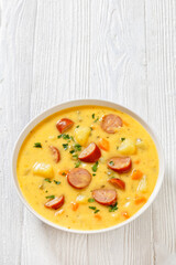 German potato soup with sausages in bowl