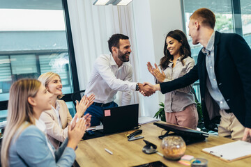 Shot of two businesspeople shaking hands during a meeting in an office