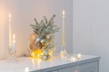 christmas decoration with burning candles in white interior