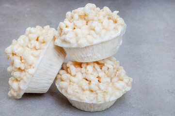 puffed and crisp rice treats with white chocolate made in tart tin on mottled grey