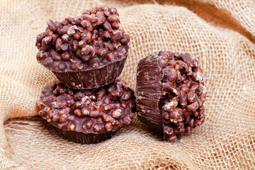 puffed and crisp rice treats with milk chocolate made in tart tin on mottled grey