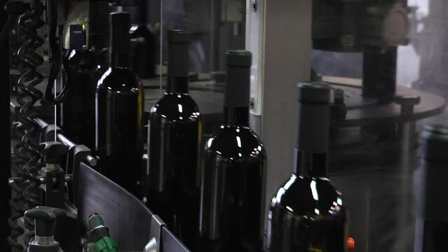 Industrial wine bottling plant machine. Modern industry production line for wine bottling and packaging