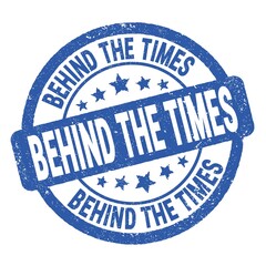 BEHIND THE TIMES text written on blue round stamp sign.