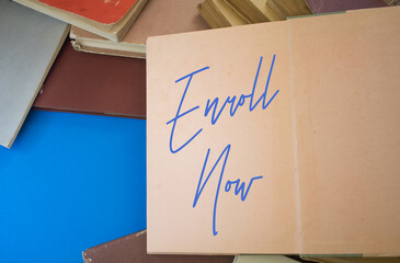 Enroll Now word in opened book with vintage, natural patterns old antique paper design.
