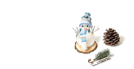 Snowman, cone, sled, spruce branch isolated on white background, copy space. Closeup of snowman...