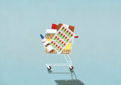 Variety of medication in shopping cart on blue background
