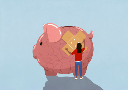 Woman placing bandage over cracked piggy bank
