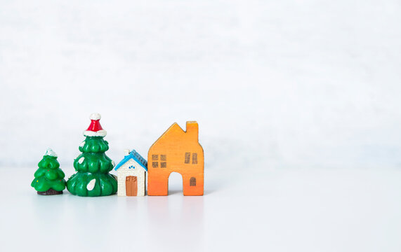 Miniature house with Christmas tree with space on white background, Festive season time, Christmas at home