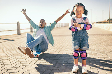 Black family, children and skate boarding with a cute girl and father playing together on the promenade of a beach in summer. Skateboard, kids and love with a daughter waiting for a skateboard chance