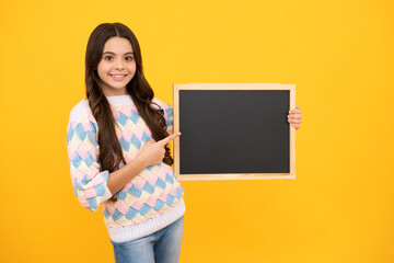 Fototapeta na wymiar Teen schoolgirl hold blackboard. Child advertising. Back to school.