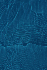 Defocus blurred transparent blue colored clear calm water surface texture with splashes and bubbles. Trendy abstract nature background. Water waves in sunlight with copy space. Blue watercolor shining