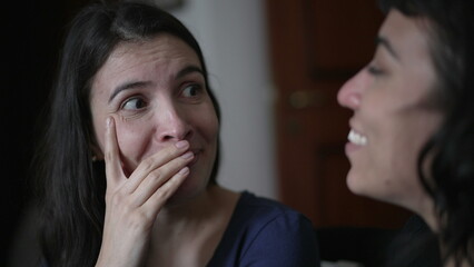 Naklejka premium Woman reacting with surprise and unbelief to news told by friend. Person closeup face emotional reaction with consternation