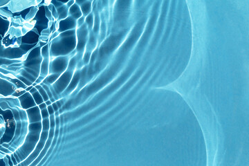 Textured background of rippled blue water with solar lightning