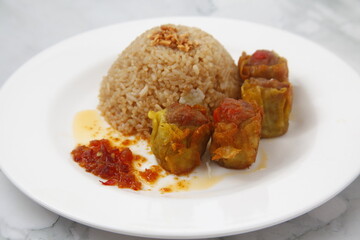 Fototapeta na wymiar Freshly cooked Filipino food called Budbod rice with fried pork siomai