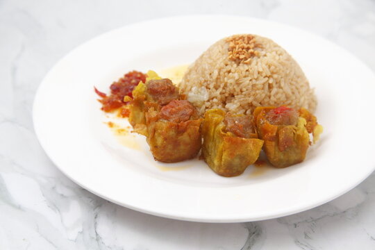 Freshly cooked Filipino food called Budbod rice with fried pork siomai