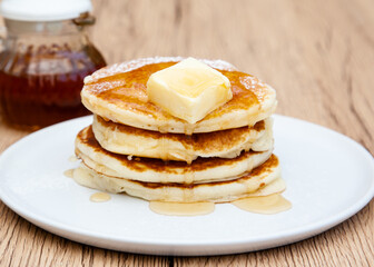 Fototapeta na wymiar Stack of freshly made buttermilk pancakes with maple syrup and butter 