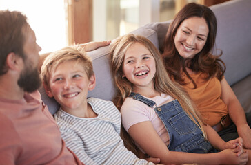 Obraz premium Happy, love and parents on a sofa with their children talking, laughing and bonding in the living room. Happiness, smile and family in comic or funny conversation while relaxing on the couch at home.