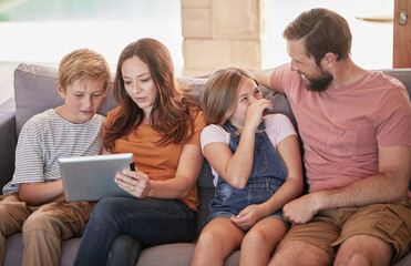 Family, sofa and tablet with children and parents streaming an online subscription in home living room. Kids, internet and video with a man, woman and kids or siblings watching series in the lounge