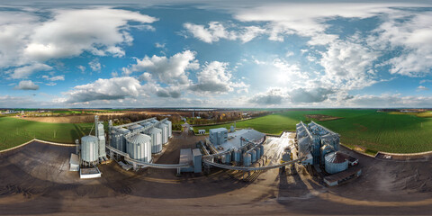 full seamless 360 hdri panorama view among farming field on rows of agro silos granary elevator...