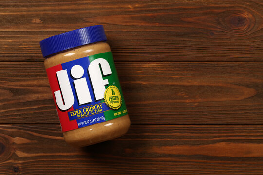 Jif peanut butter jar on a wooden background, top view, flat lay with copy space