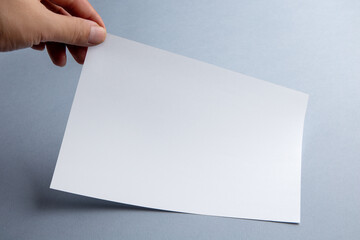 Obraz premium White blank paper page with shadow isolated on blue background