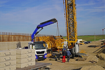 Folding crane mounting on a bridge construction site for the overpass of a service road over the future A143 motorway