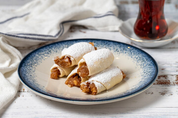 Apple cookies on a white wooden background. Cookies filled with applesauce. Mediterranean cuisine delicacies. Bakery desserts. close up