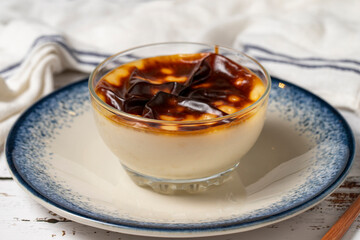 Rice pudding on a white wooden background. Mediterranean cuisine delicacies. Local name sutlac. Close-up