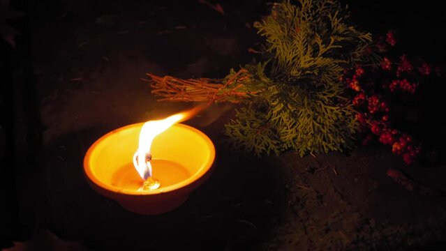 Candle Flames on Cemetery an Night, All Saint's Day , Death Holiday Lantern, 1 November Candles, Fallen Leaves, Blurred Background