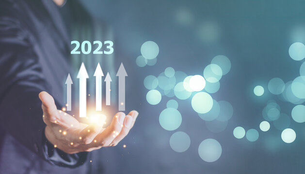 New Goals, Plans and Visions for Next Year 2023. Businessman draws increase arrow graph corporate future growth year 2022 to 2023. Planning,opportunity, challenge and business