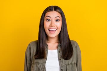Portrait of astonished ecstatic optimistic girl with long hairstyle dressed khaki shirt open mouth...