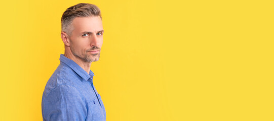Man face portrait, banner with copy space. serious man with gray beard. hair and beard care. male fashion model on yellow background.