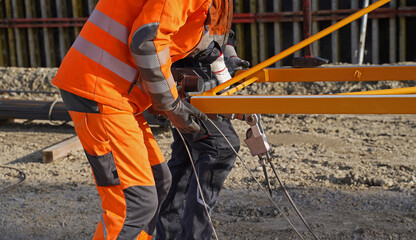 Folding crane mounting on a bridge construction site for the overpass of a service road over the future A143 motorway