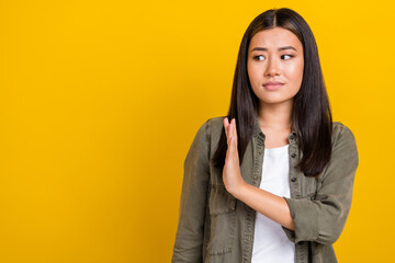 Portrait of sad upset serious woman with long hairdo wear khaki shirt look empty space hold palm...