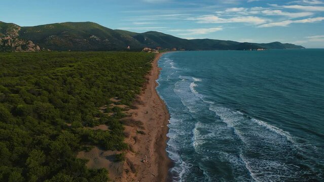 Natural sand beach seaside in Tuscany, Italy. Cinemagraph seamless video loop aerial of tourist vacation sea coast bay with clear blue water and yellow sand. Calm animation graphic wallpaper in 4K UHD