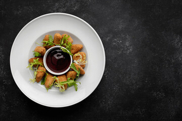 Cheese nuggets with sauce on a plate