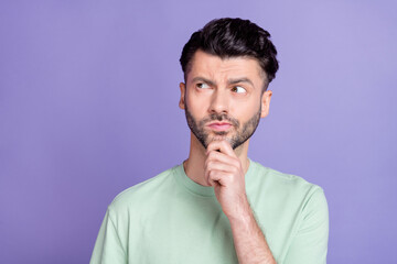 Photo of thoughtful guy with brunet hairstyle stubble wear t-shirt finger on chin look empty space...
