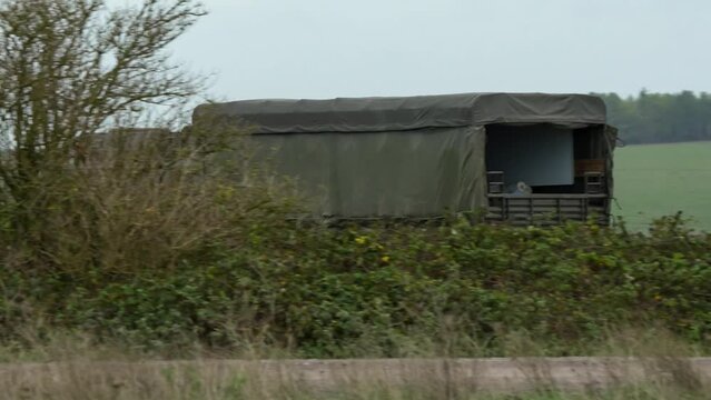 British army MAN SV 4x4 logistics lorry truck travelling at speed along a dirt track on a military exercise, Wilts UK