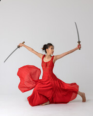 Aikido master woman in red dress with sword, katana on white background. Healthy lifestyle and...