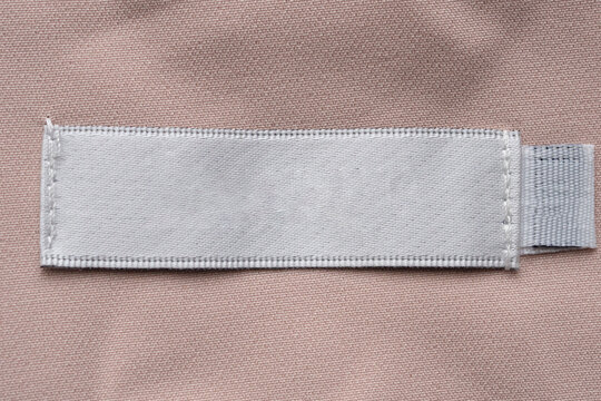 Blank laundry care clothes label on fabric texture background