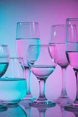 Wine glasses with neon multicolor light