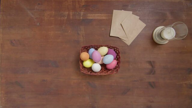 Top view of a table with items to create a composition for Easter. Women's hands arrange paints on the table. Church holiday-Easter
