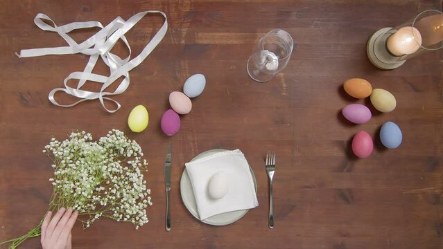 Top view of a table with items to create a composition for Easter. Women's hands arrange objects on the table. Church holiday-Easter