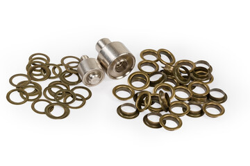 Two heaps of metal eyelets components and setting tool