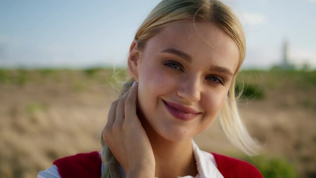 Gorgeous lady resting field portrait. Smiling model looking camera seductively