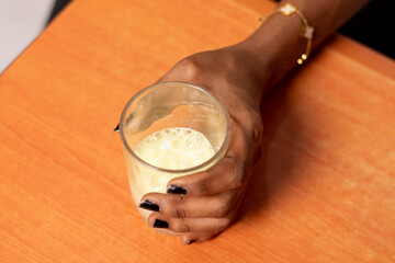 african lady holding a glass of laxative