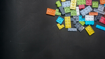 Plastic toy block on a black background